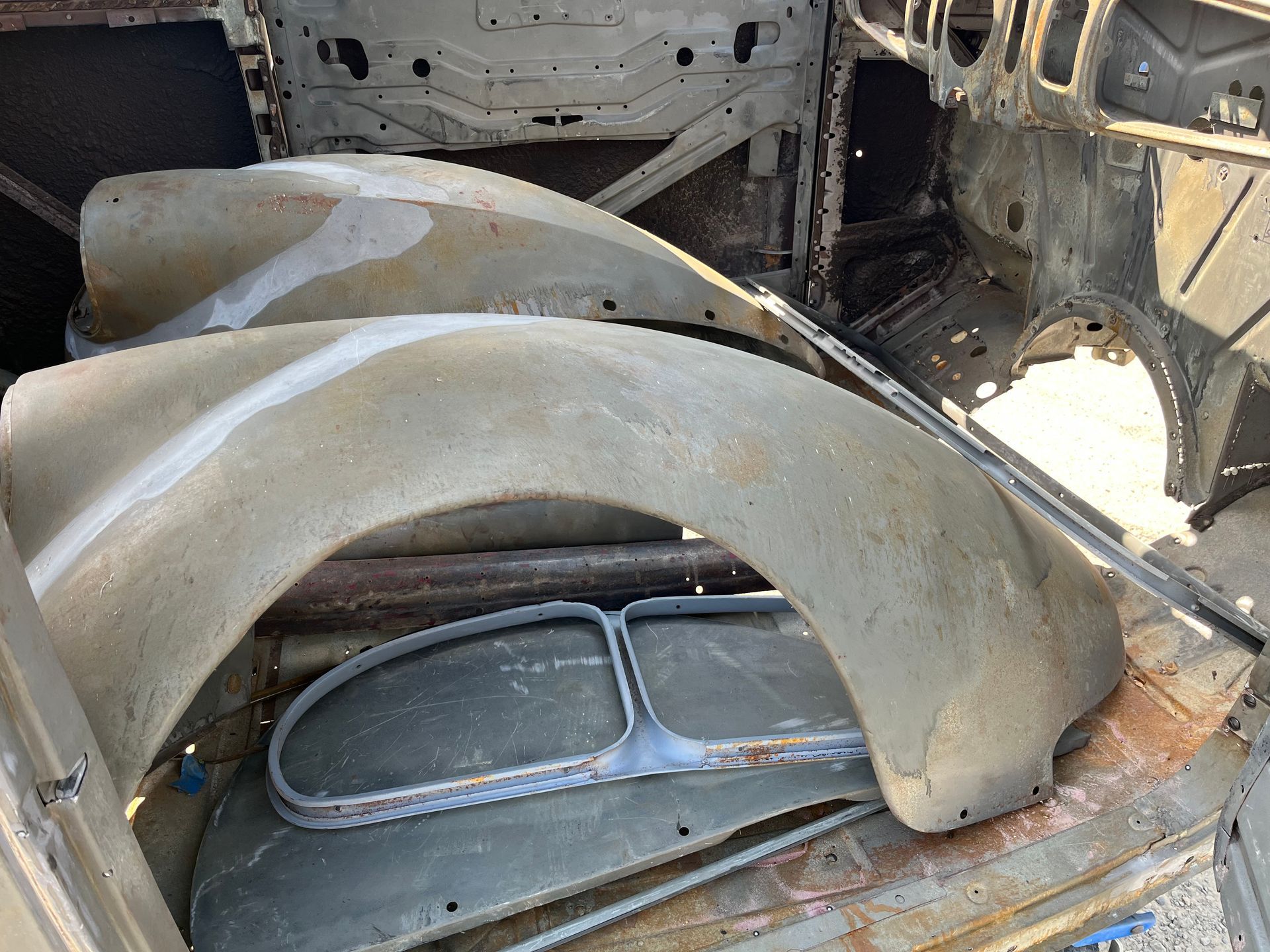 Rusty wheel well inside a stripped car body