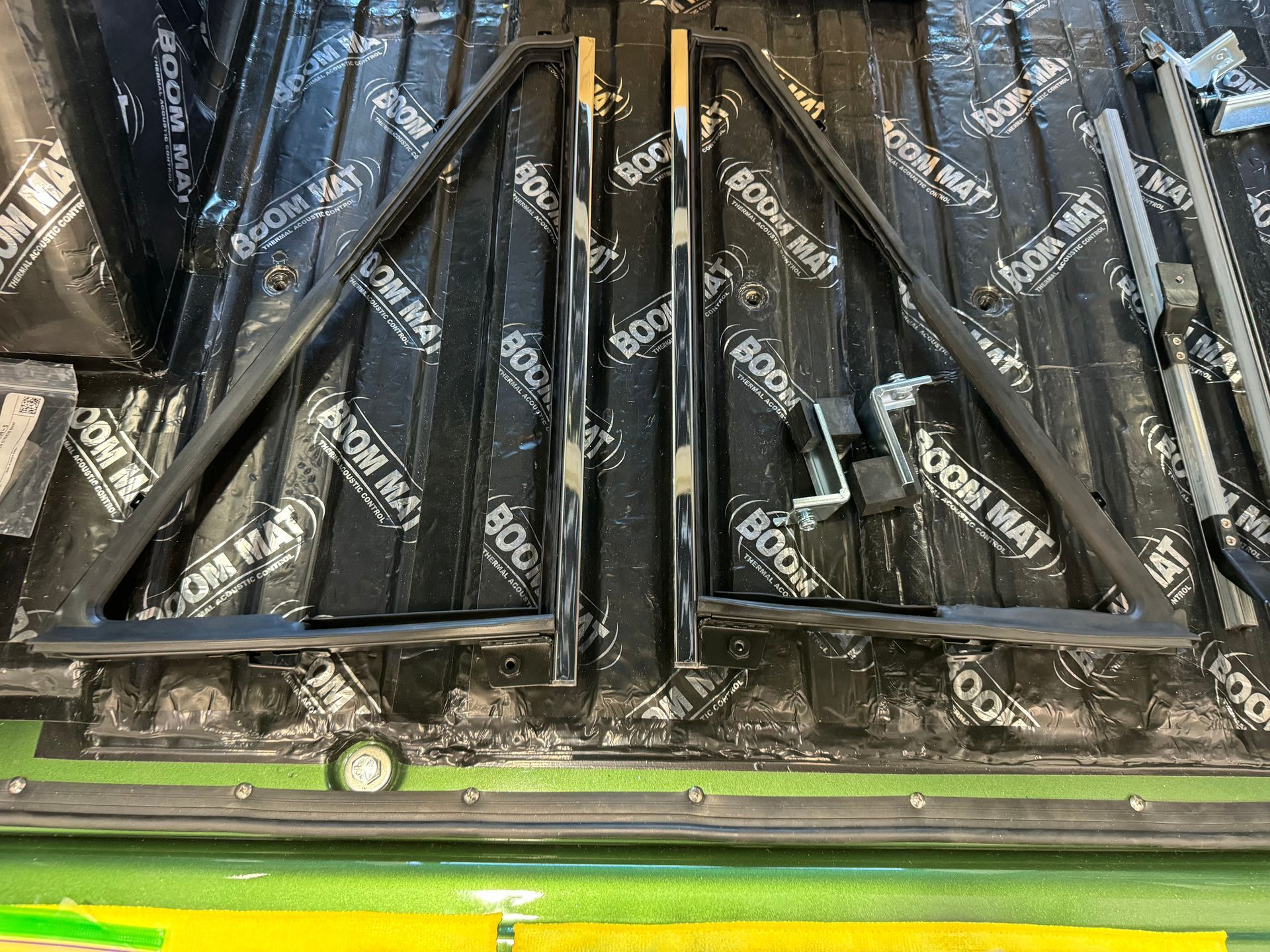 Tray of black wrapped candy bars in a store display, with green trim at the bottom
