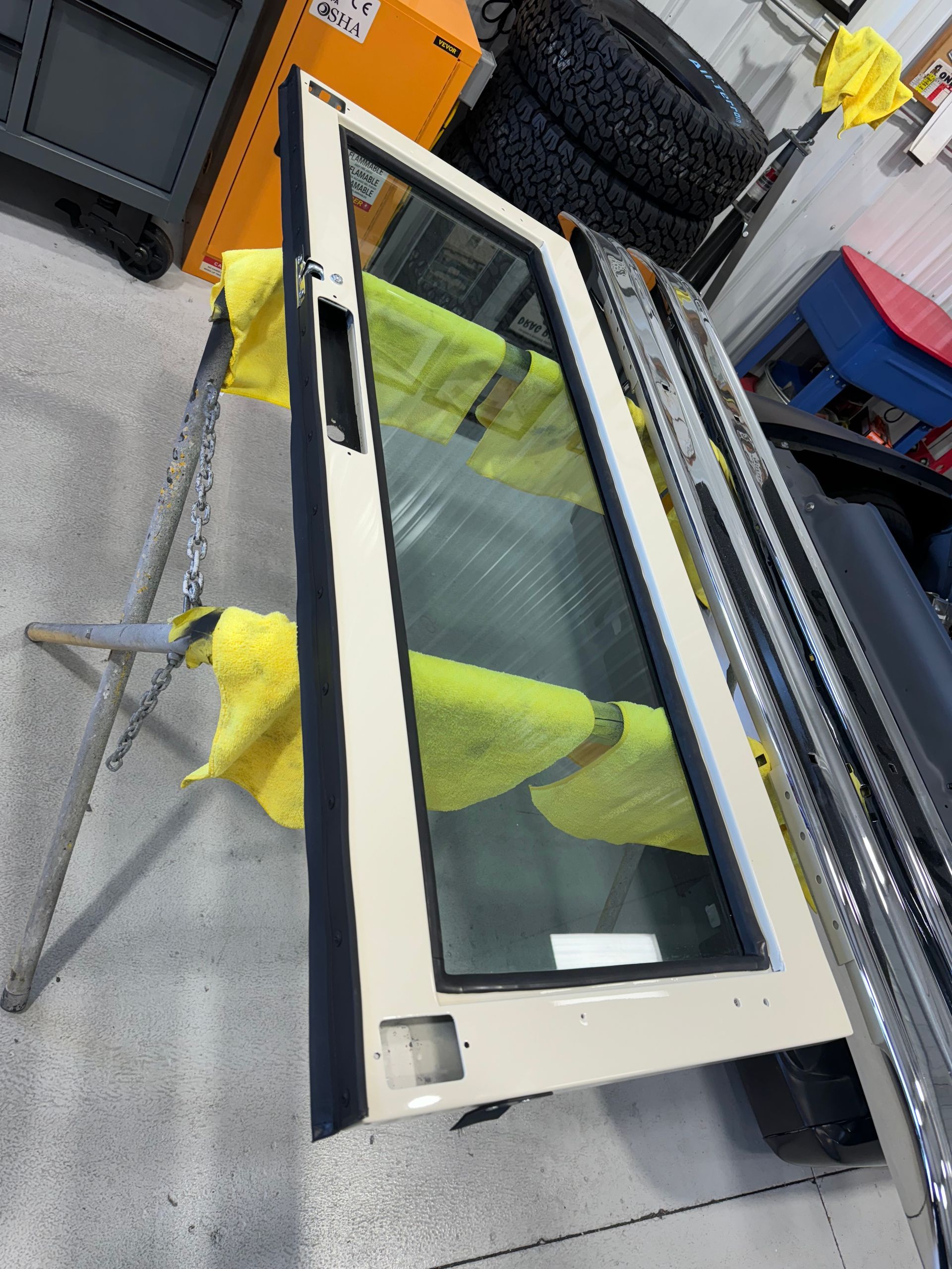 Open window frame on a workbench with yellow tape in an industrial shop
