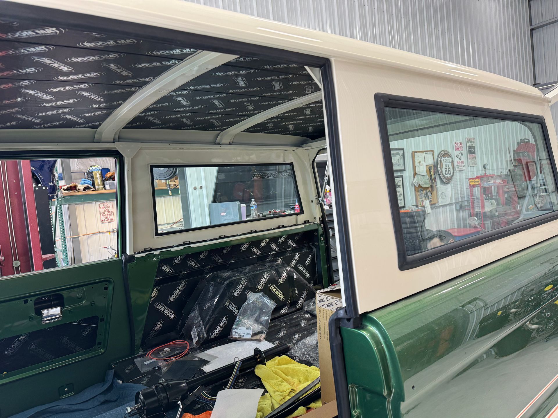 Inside a green vintage van with partially stripped interior and windows visible on the side.