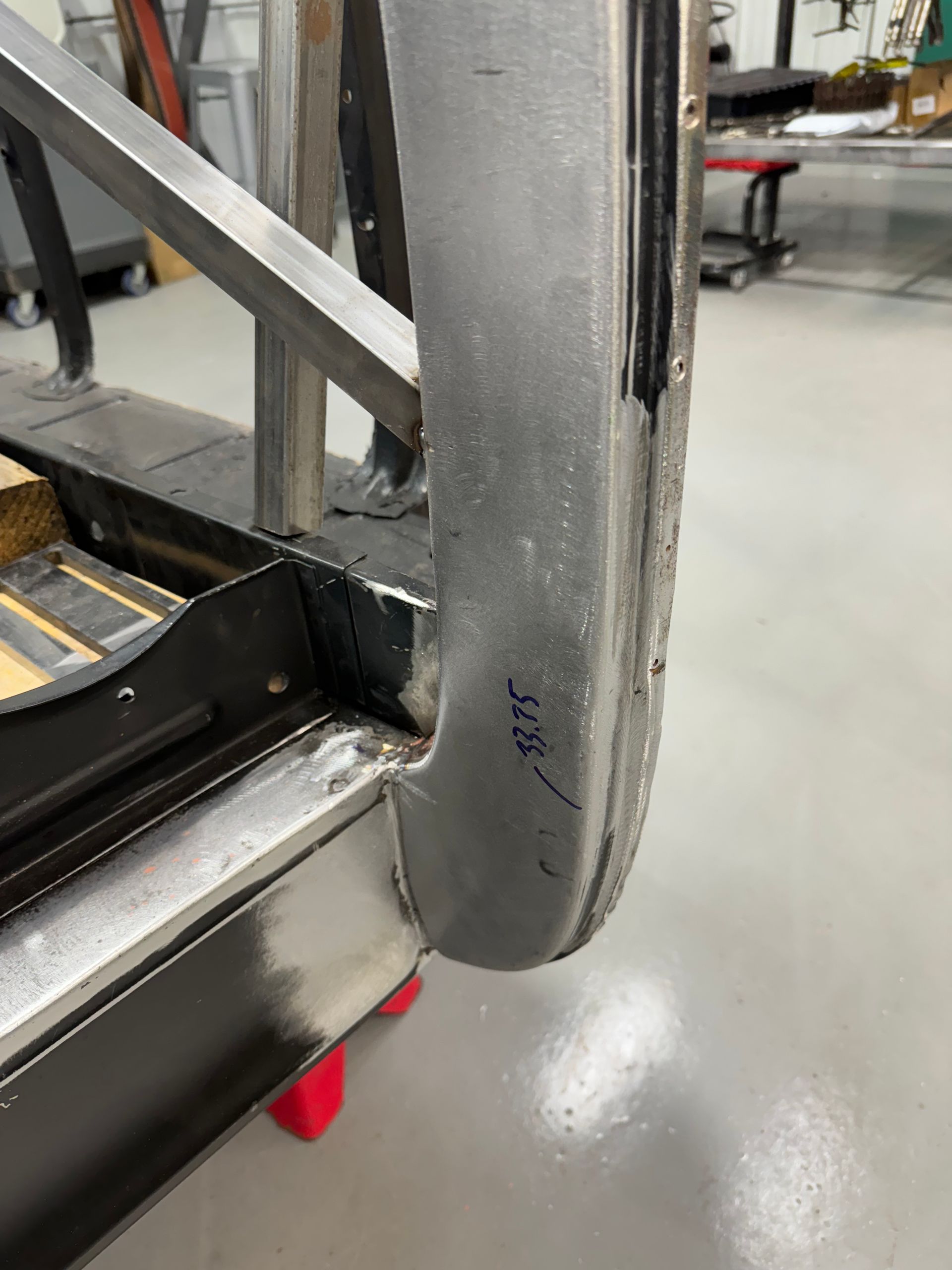Close-up of a gray padded door edge on a metal cart or machine in a workshop.