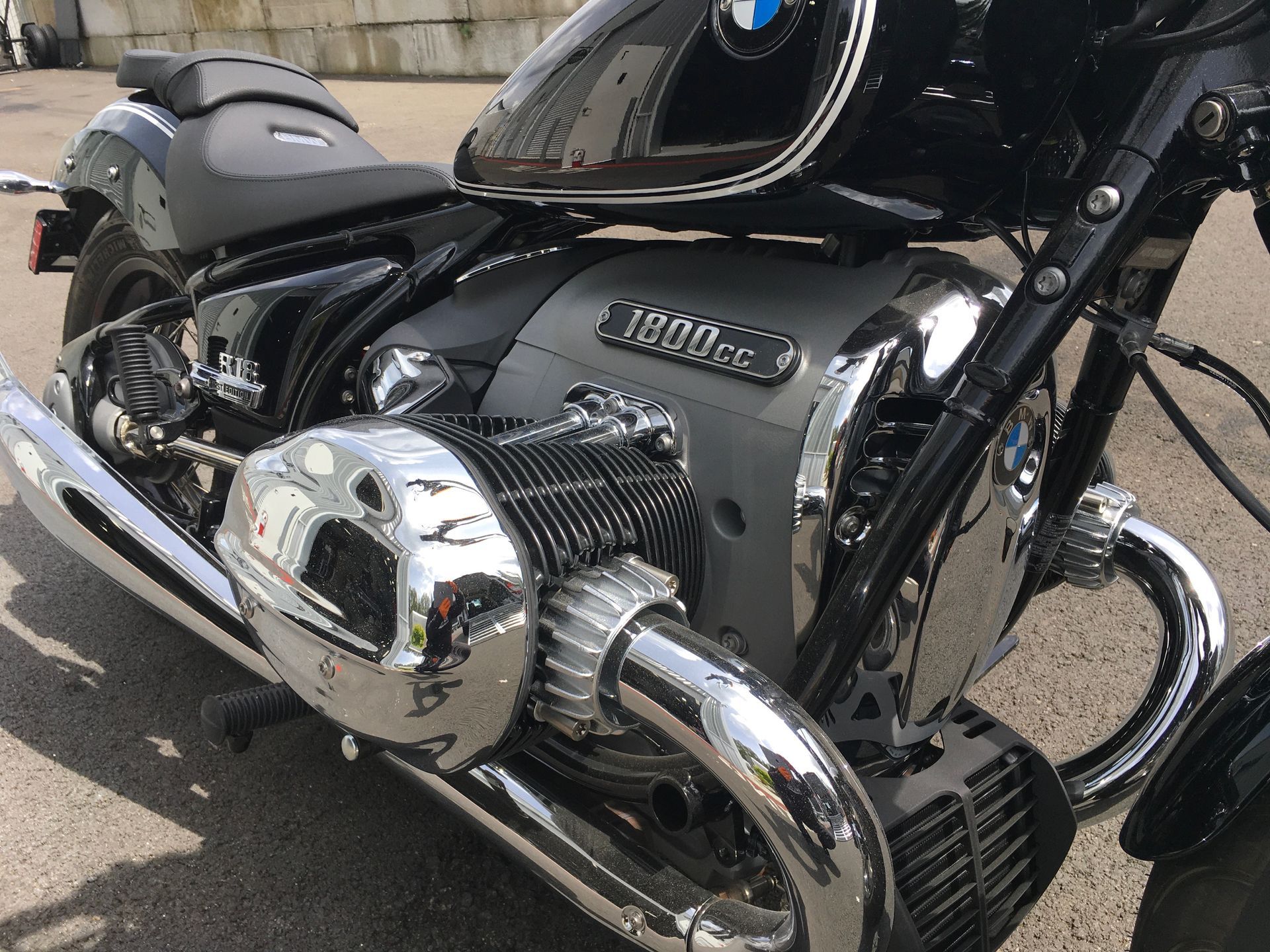 Black BMW motorcycle with chrome engine detail parked outdoors