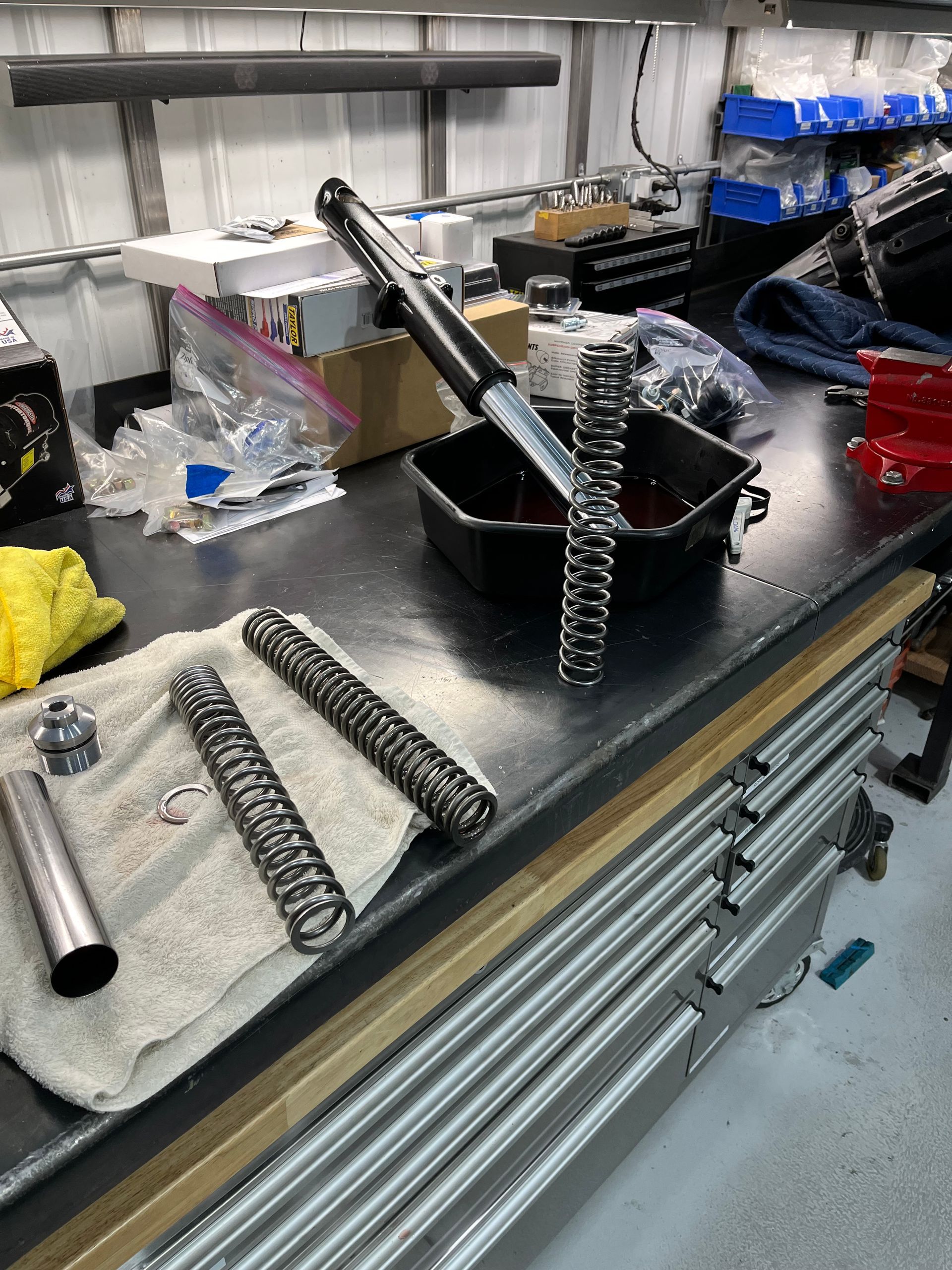 Workbench with disassembled metal springs and tools in an industrial workshop
