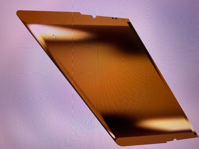 Copper-colored metal plate on a light background, shown at an angle.
