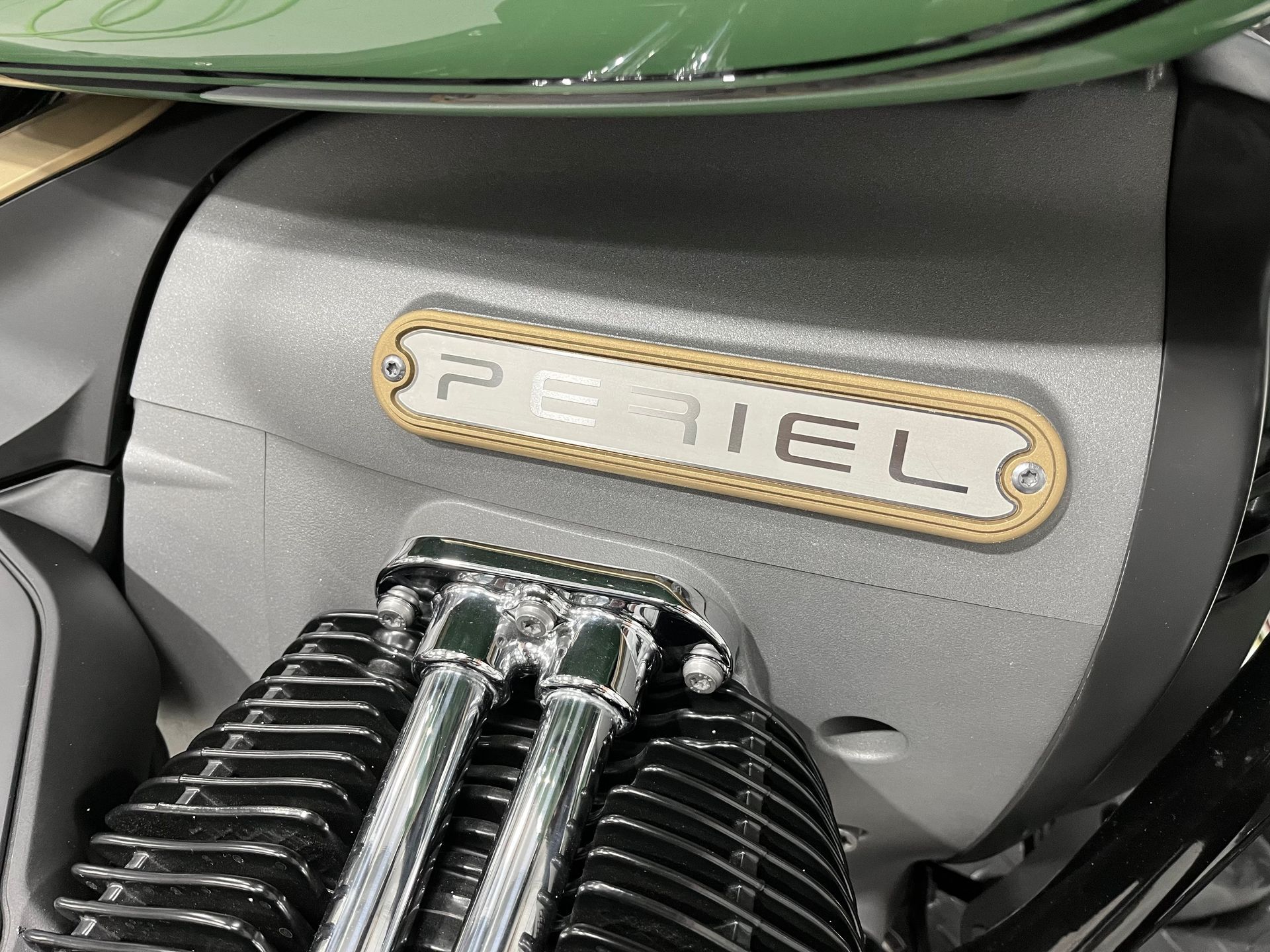 Close-up of a green PEEL scooter engine with chrome springs and a vintage badge