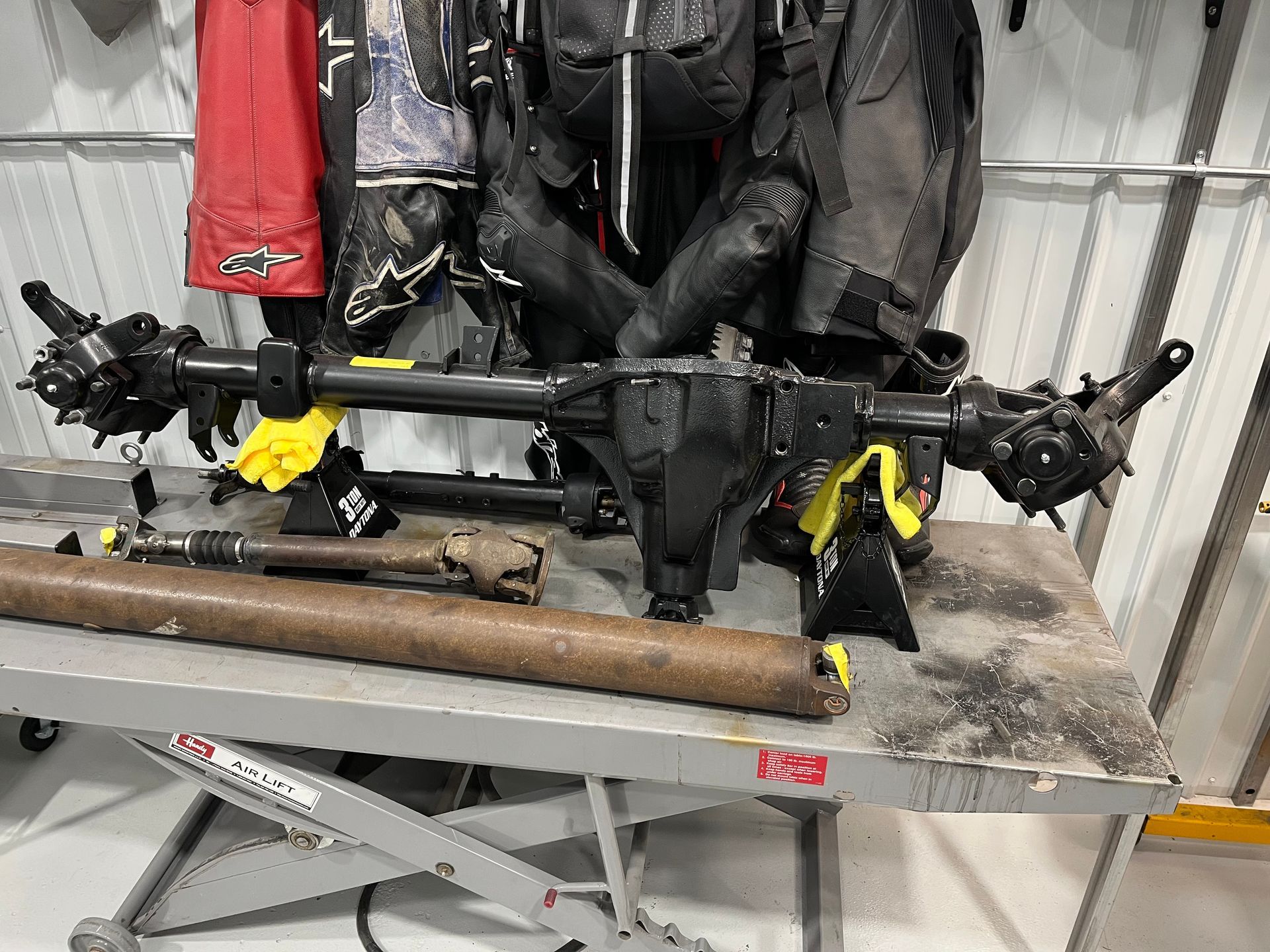 Black drone-like machine mounted on a metal workbench in a garage or workshop