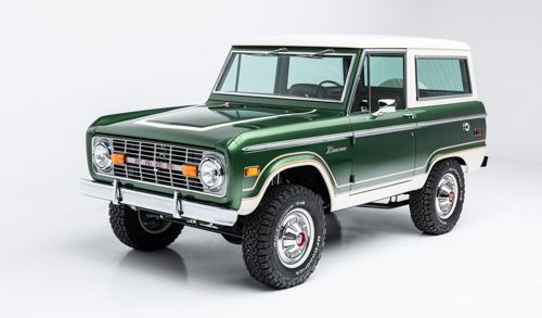 Classic green-and-white vintage Ford Bronco on a white studio background