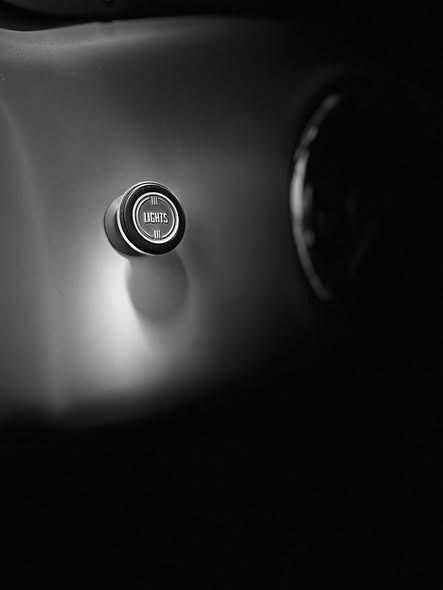 Close-up of a car dashboard button labeled “ECO” with a dark background