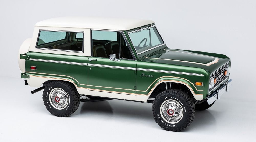 Green vintage SUV on a white background, shown in side view.