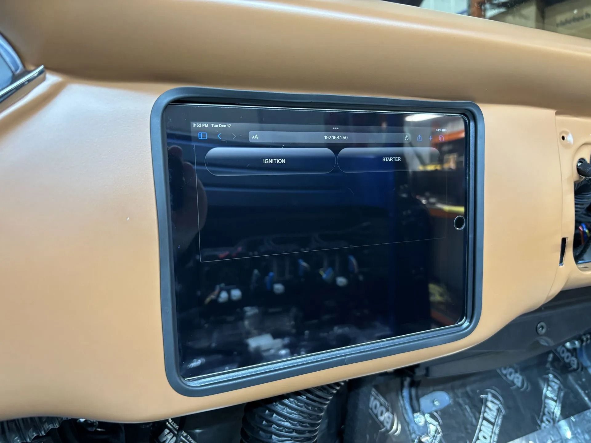 Close-up of a car dashboard touchscreen with a tan interior trim.