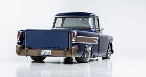 Classic blue and gray custom pickup truck, rear view on a white studio background