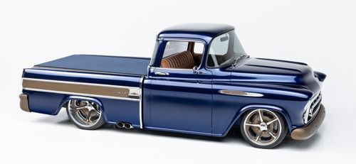 Blue vintage custom pickup truck with chrome wheels on a white background