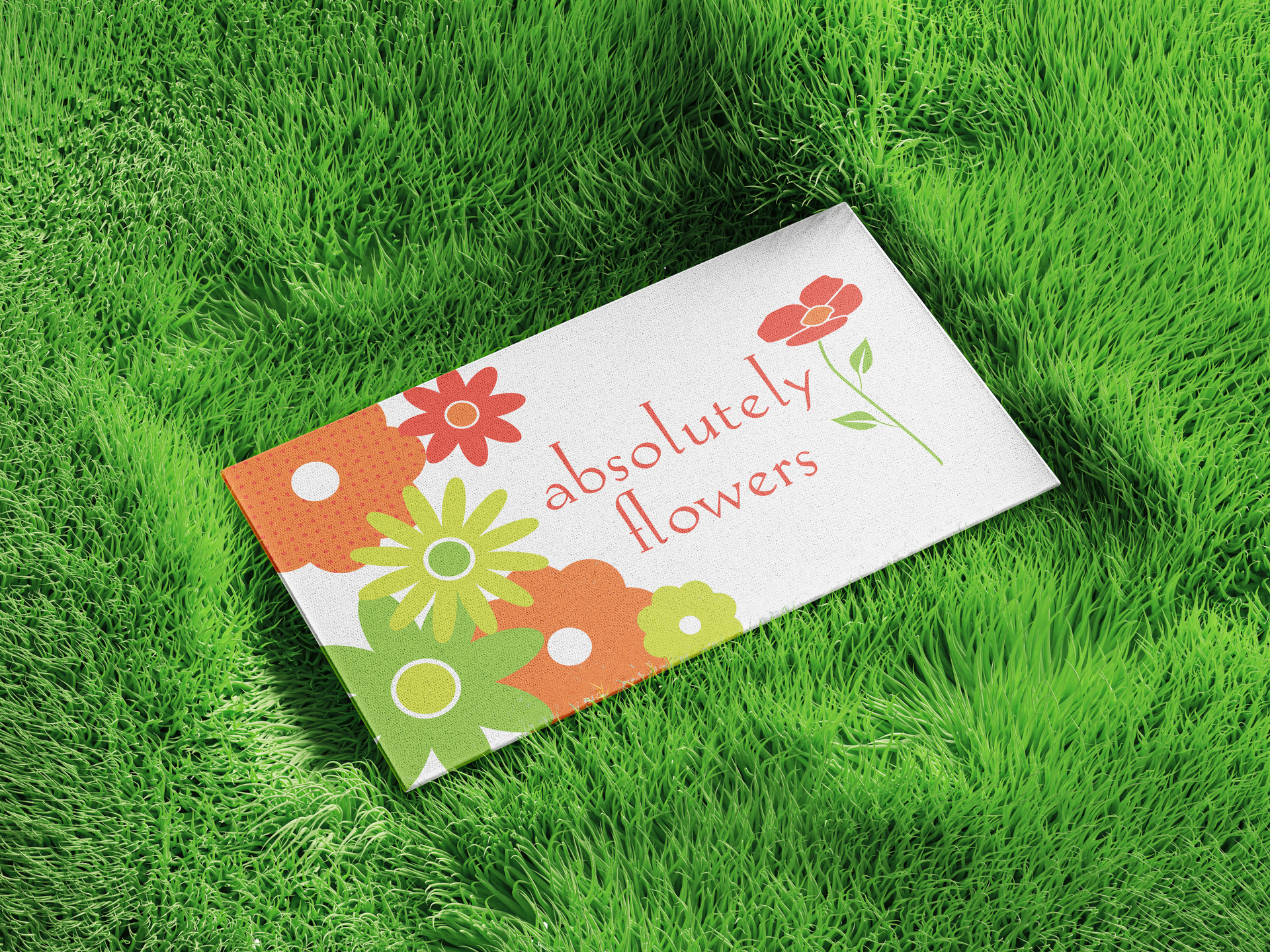 Business card on green grass with the text 