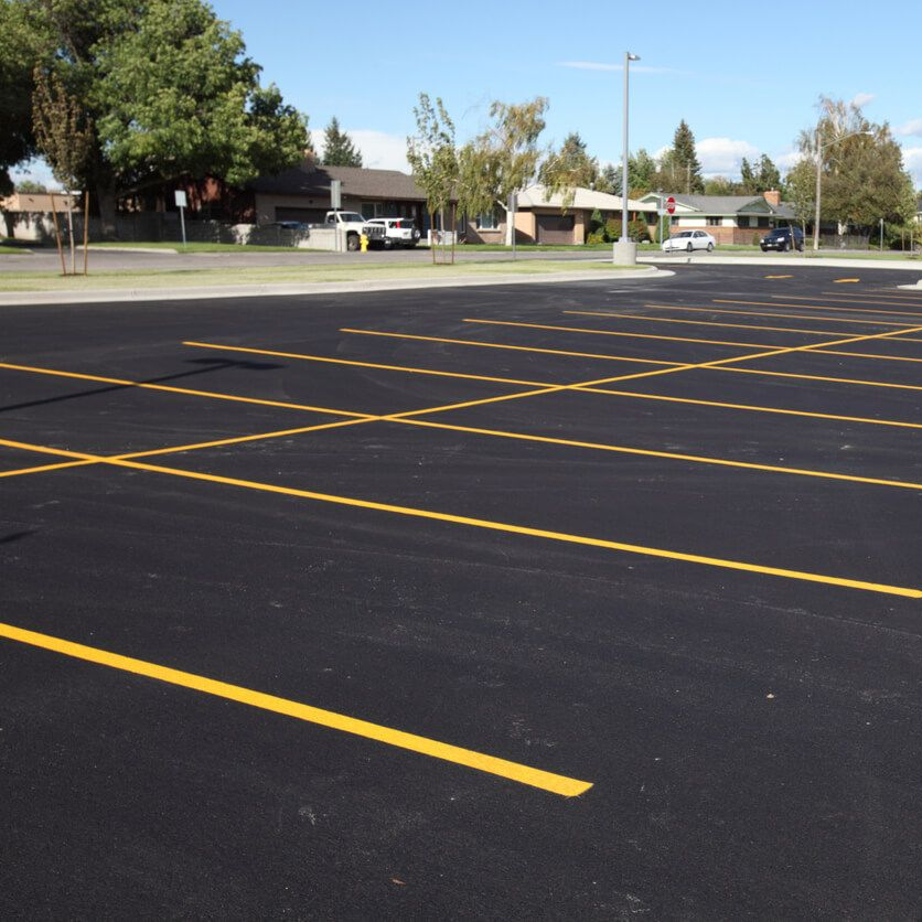 Newly striped commercial parking lot with yellow stall lines in San Antonio, TX