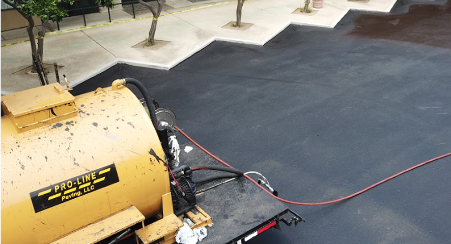 Asphalt paver laying hot mix on a commercial parking lot in San Antonio