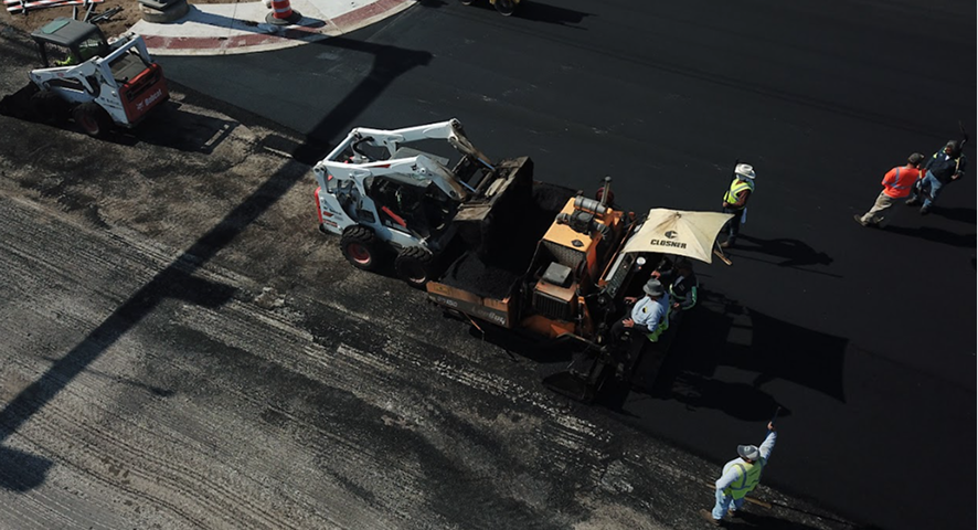 Milling machine grinding asphalt on a San Antonio parking lot
