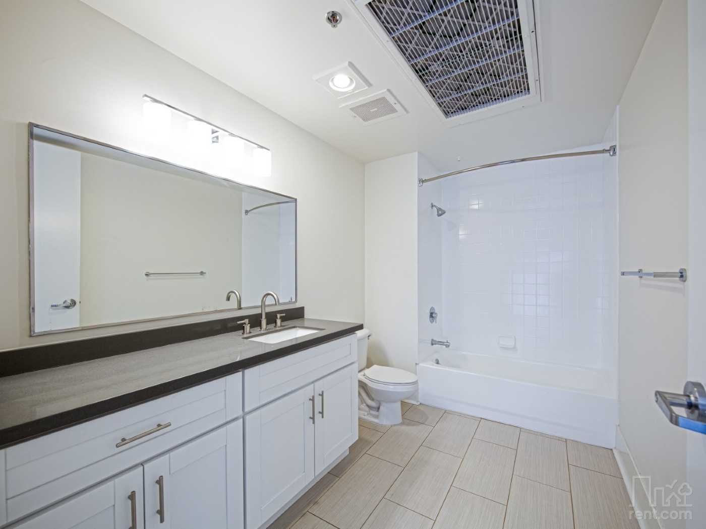 A bathroom with a sink , toilet , and bathtub.