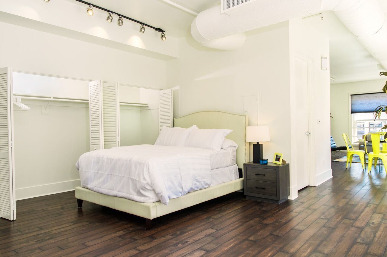 A bedroom with a king size bed and a bunk bed.