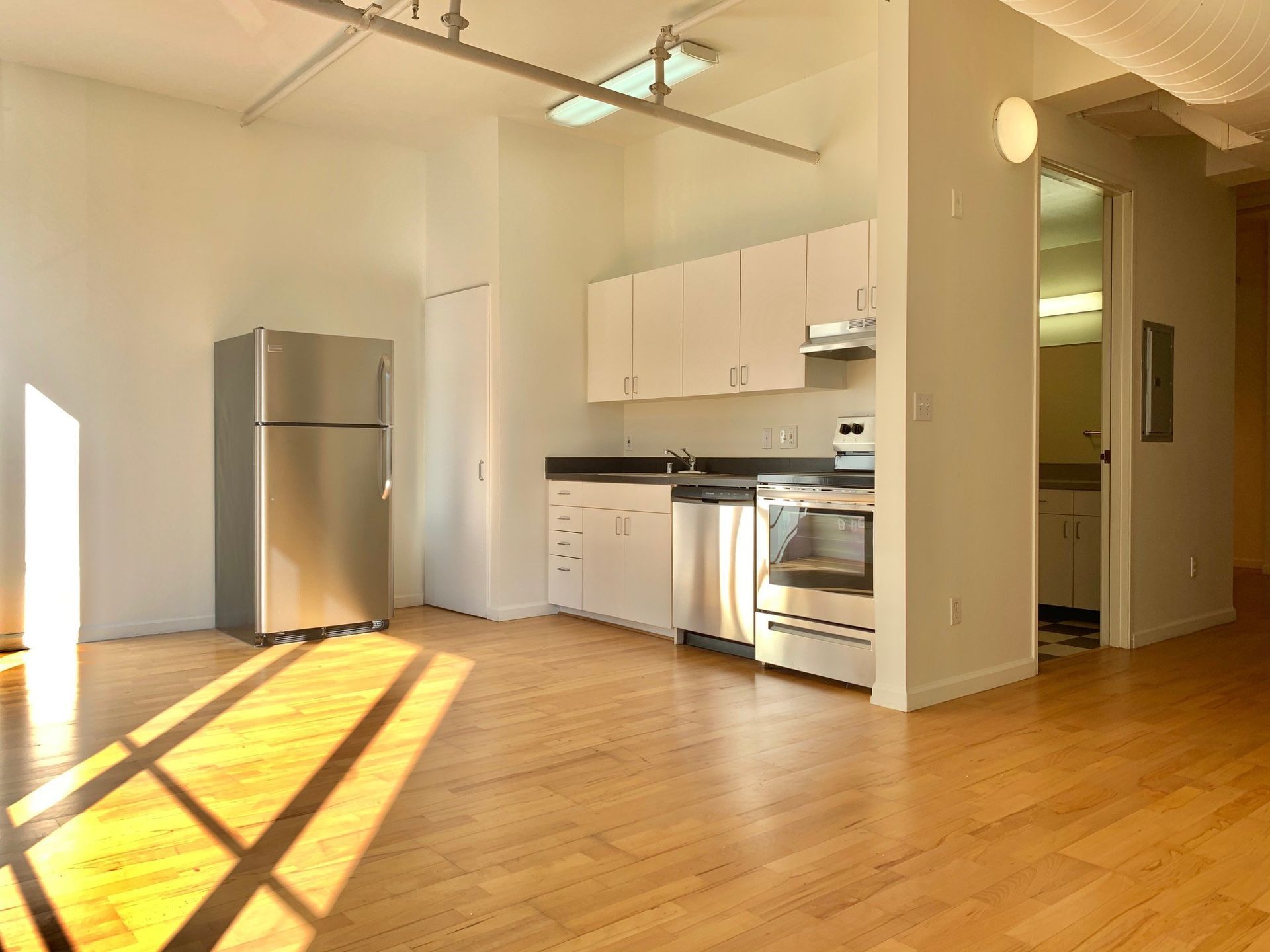 A kitchen with stainless steel appliances and white cabinets