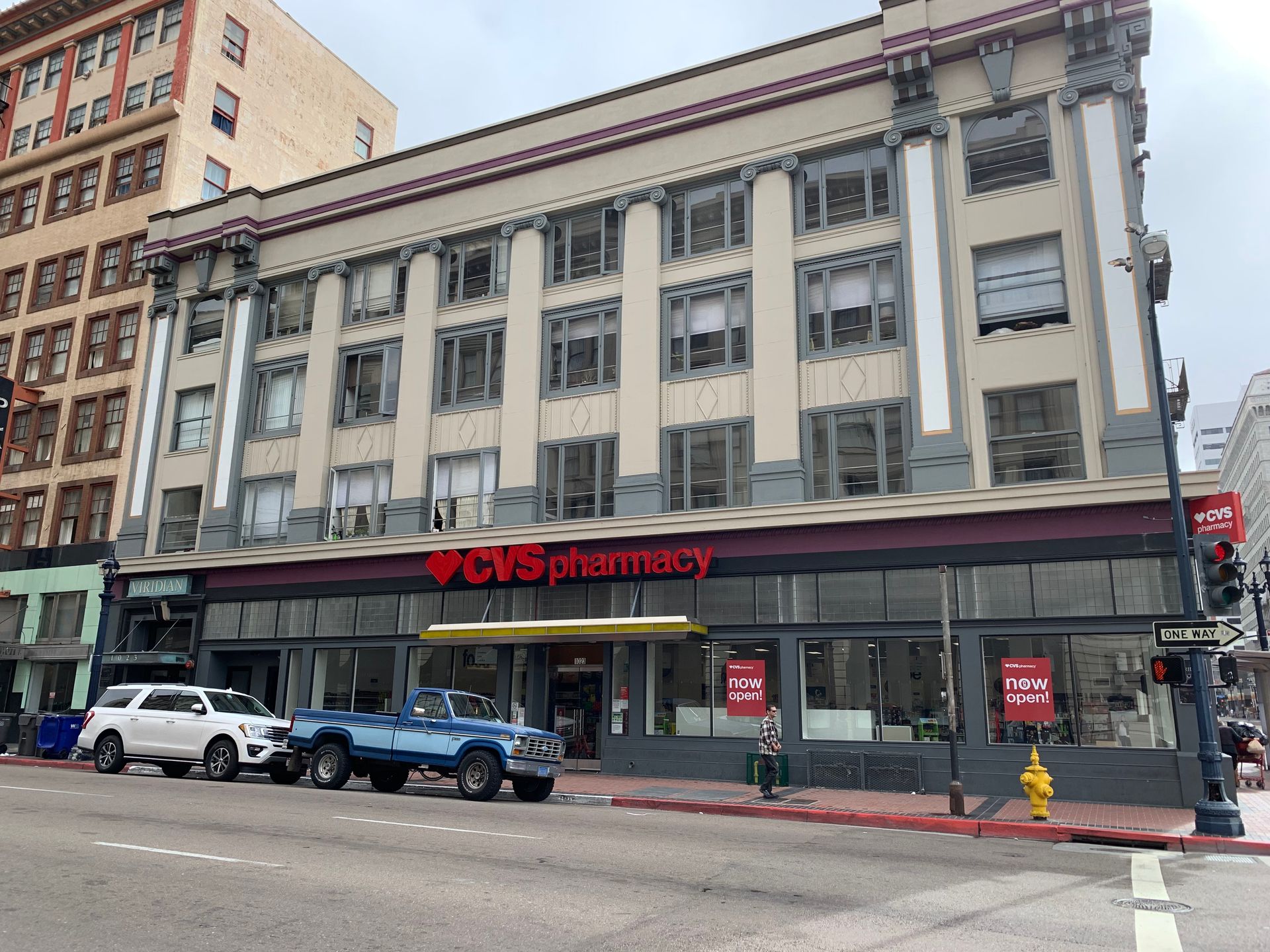 A cvs pharmacy is located on the corner of a city street.