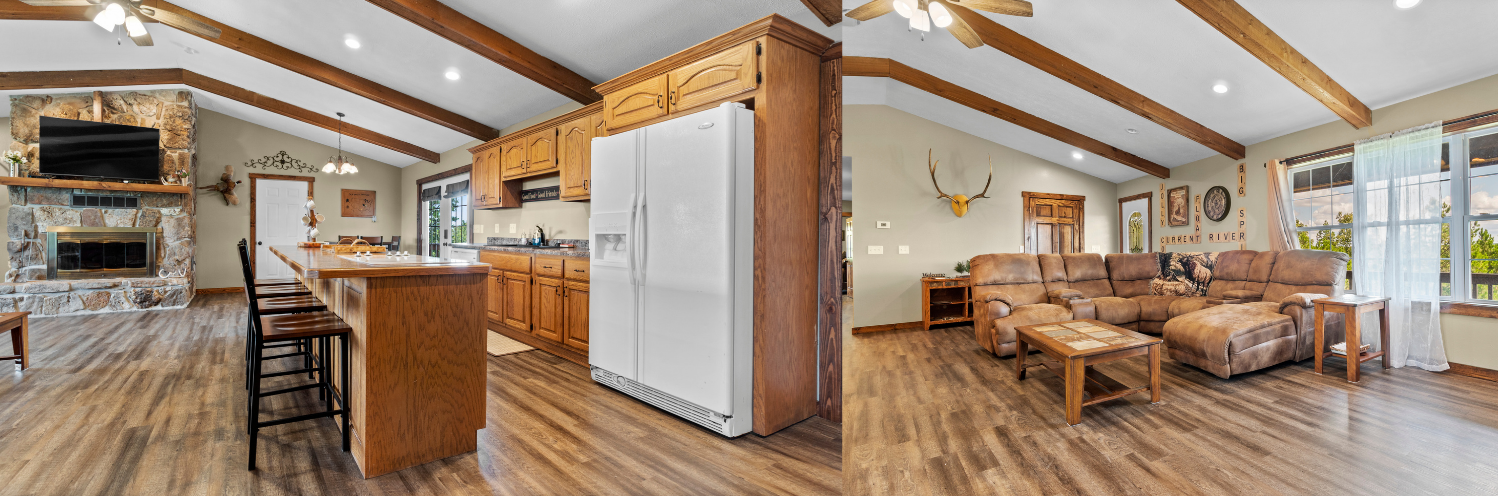 Open-plan kitchen and living room with wood beams, white fridge, and wicker dining area