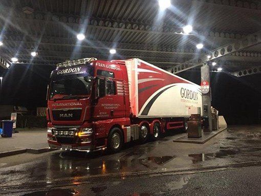 Red Ian Gordon truck in fuelling garage