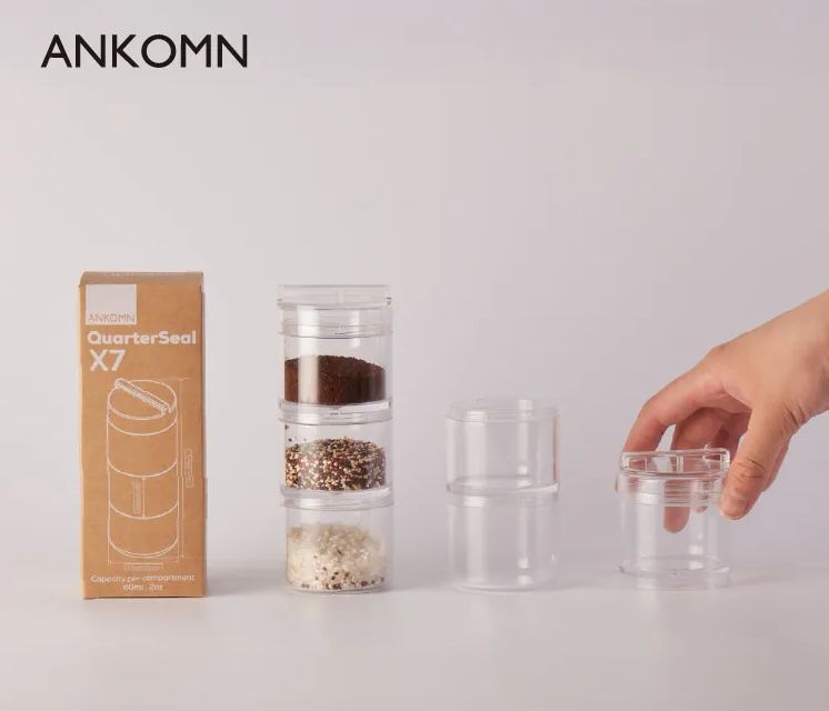 Transparent cylindrical container with a black cord attached, branded ANKOMN on white background