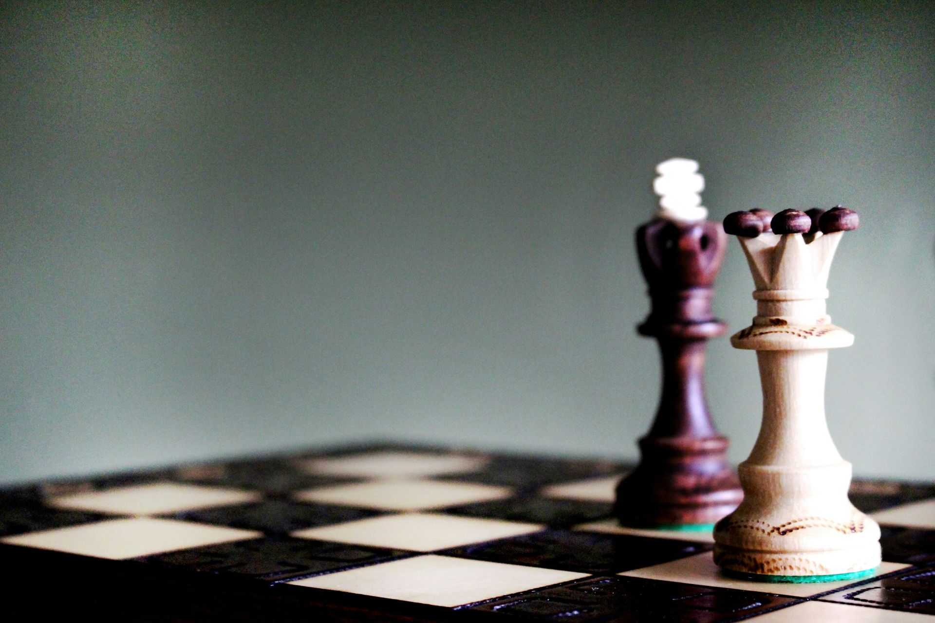 A couple of chess pieces on a checkered board