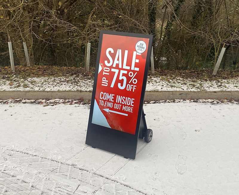 digital a-board outside on a path