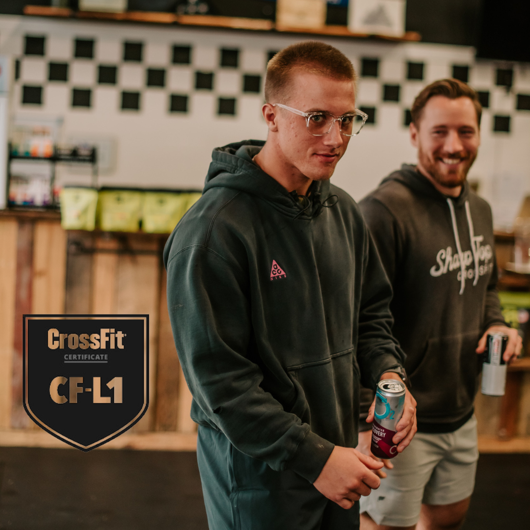 Two men are standing in front of a sign that says crossfit cf-l1