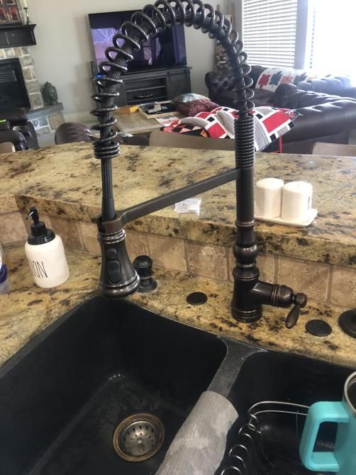 a man is fixing a pipe with a wrench
