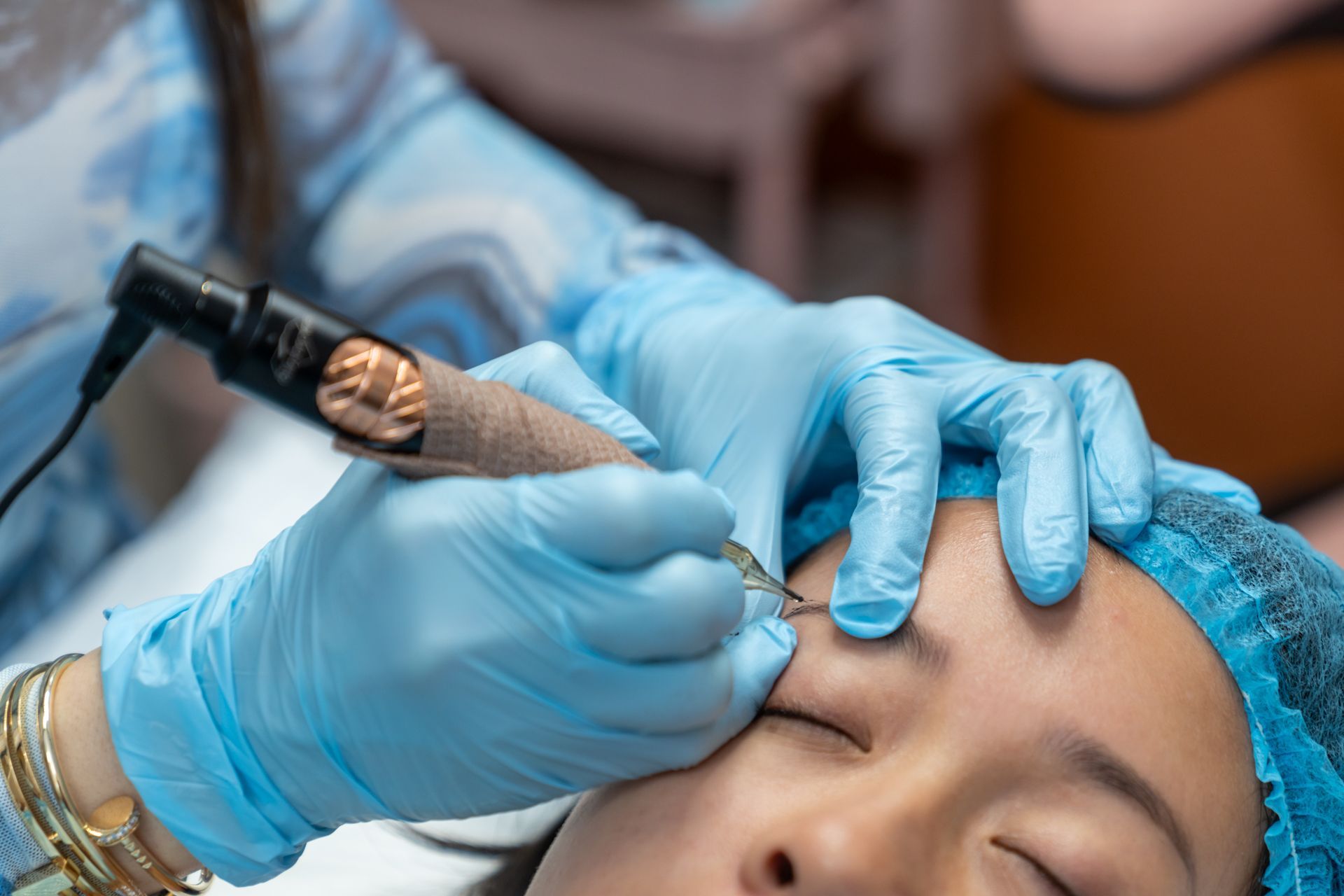 Professional cosmetic eyebrow tattoo and permanent makeup procedure in beauty clinic