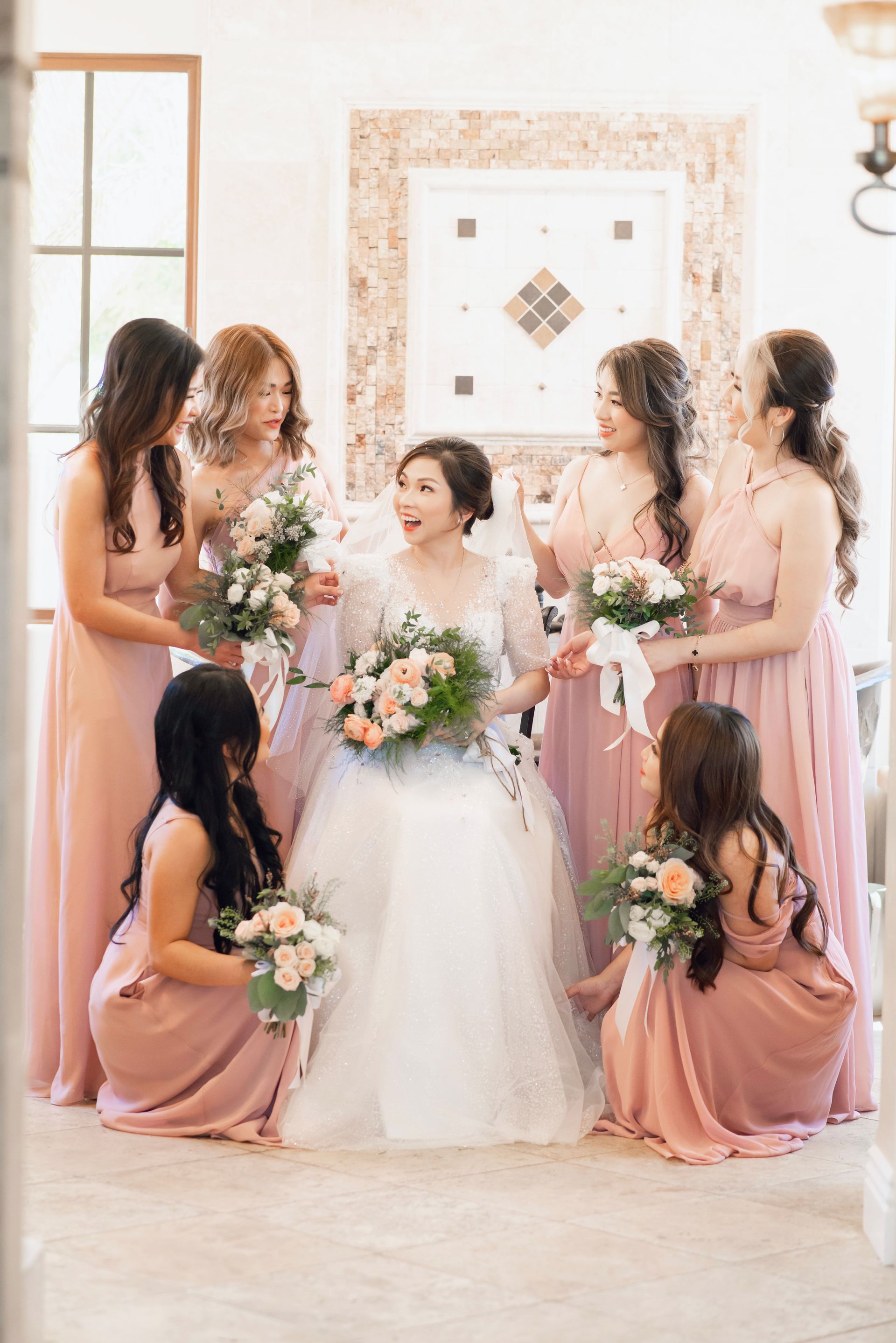 A photo of a bride surrounded by bride's maids.