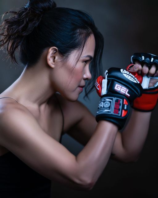 A fine art portrait of a woman in boxing gloves