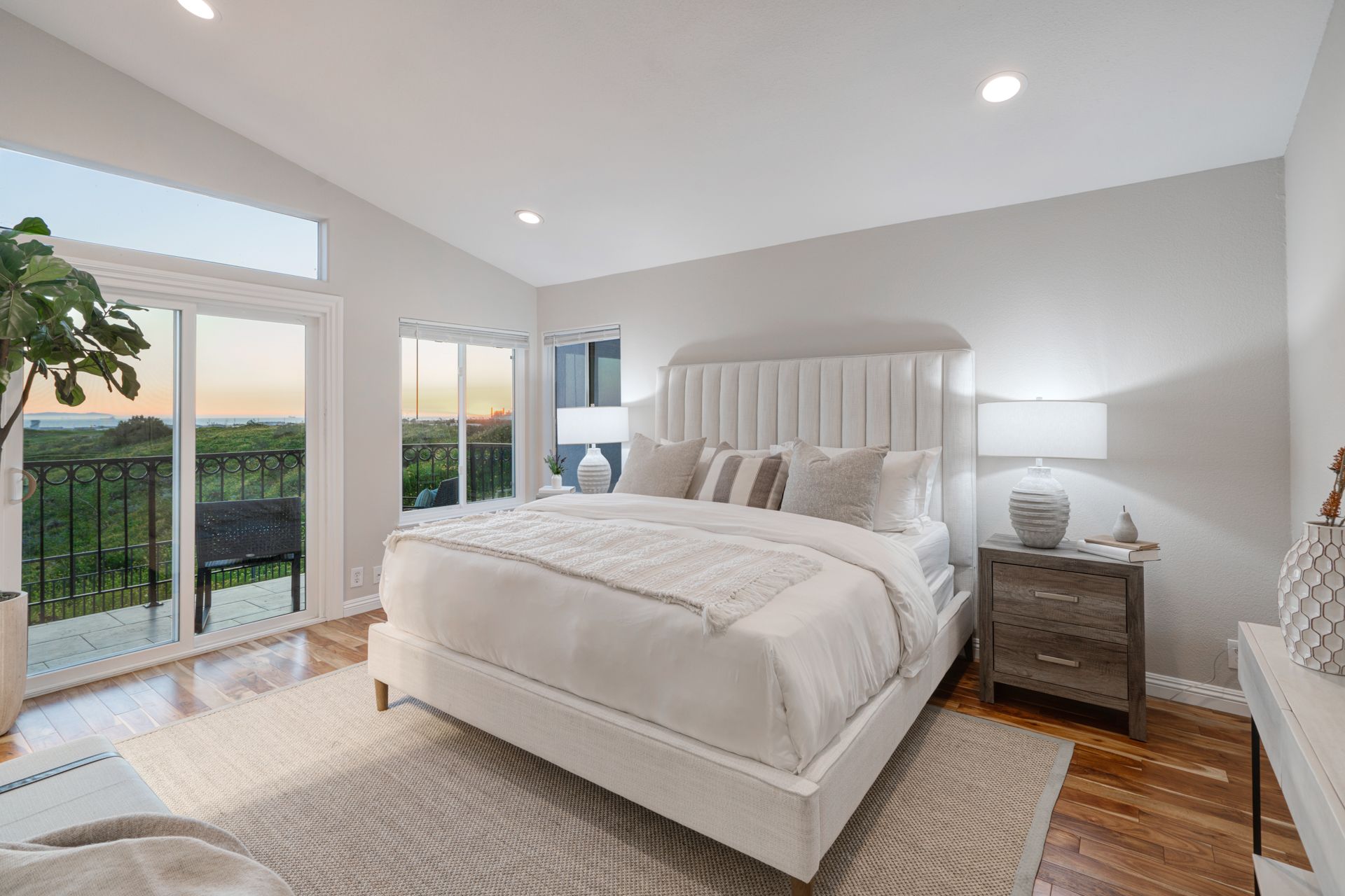 Bright luxury bedroom interior with modern decor and large balcony windows