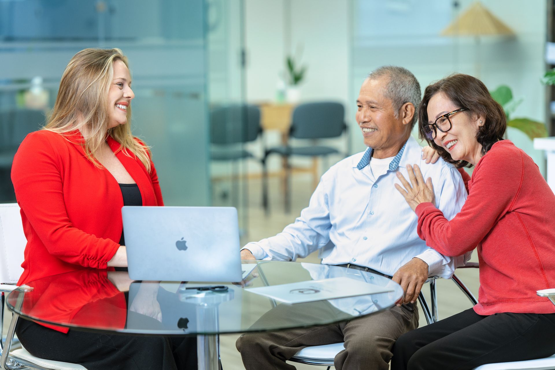 Professional consultation meeting with family reviewing information together on laptop