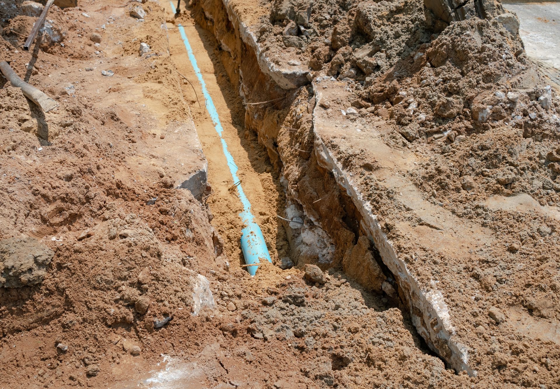 Underground water line installed in a trench during utility infrastructure construction work.]