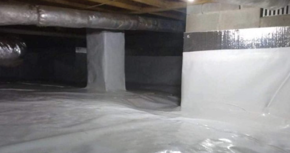 A basement with a lot of concrete and a lot of drains.