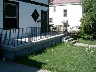 Iron Railings Bordering Concrete Patio