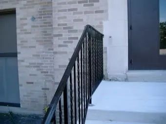 Iron Railings Leading to Brick Building