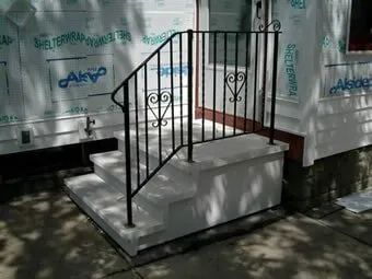 Precast Concrete Steps and Iron Railings in Front of New Home