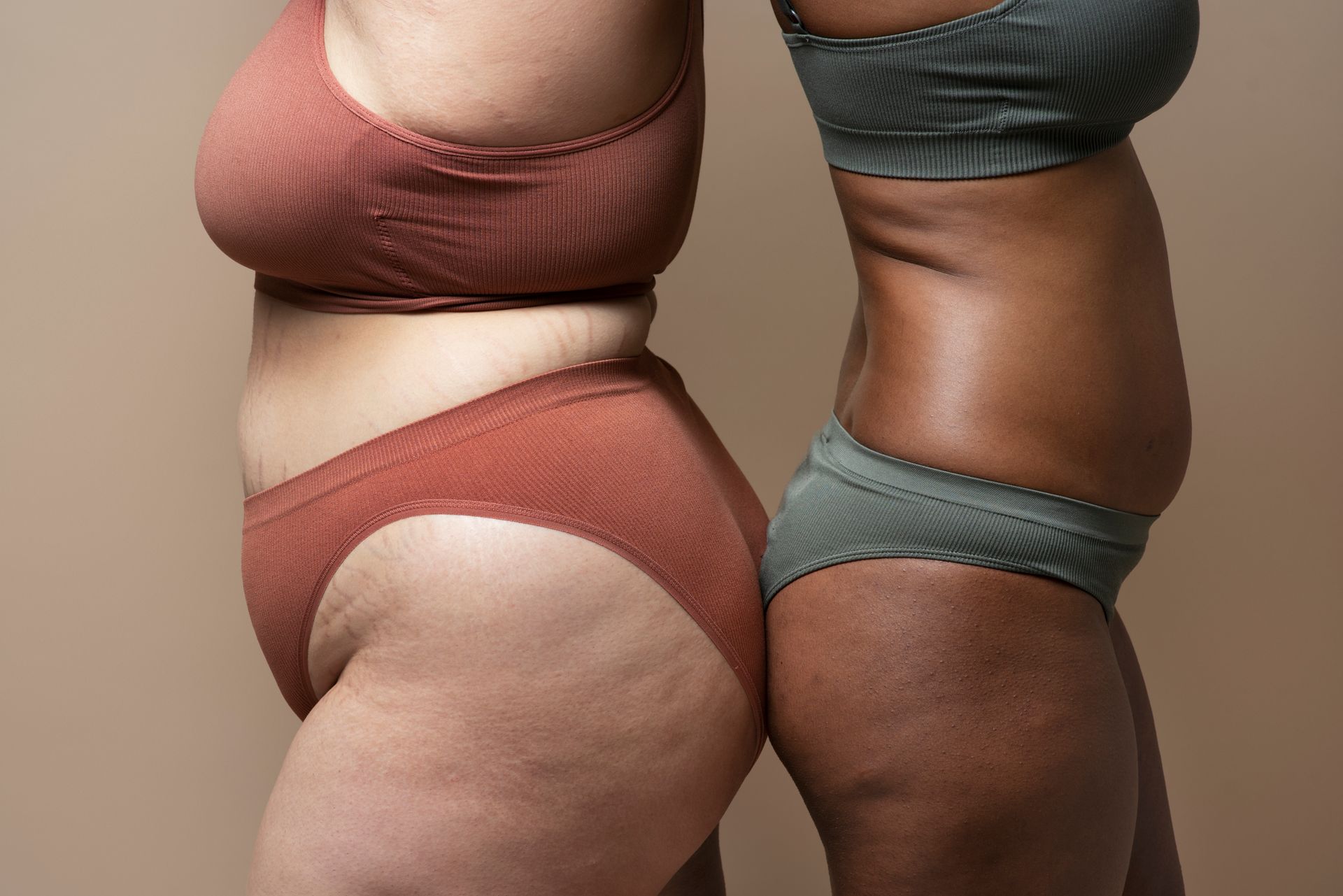 two women are standing next to each other in underwear