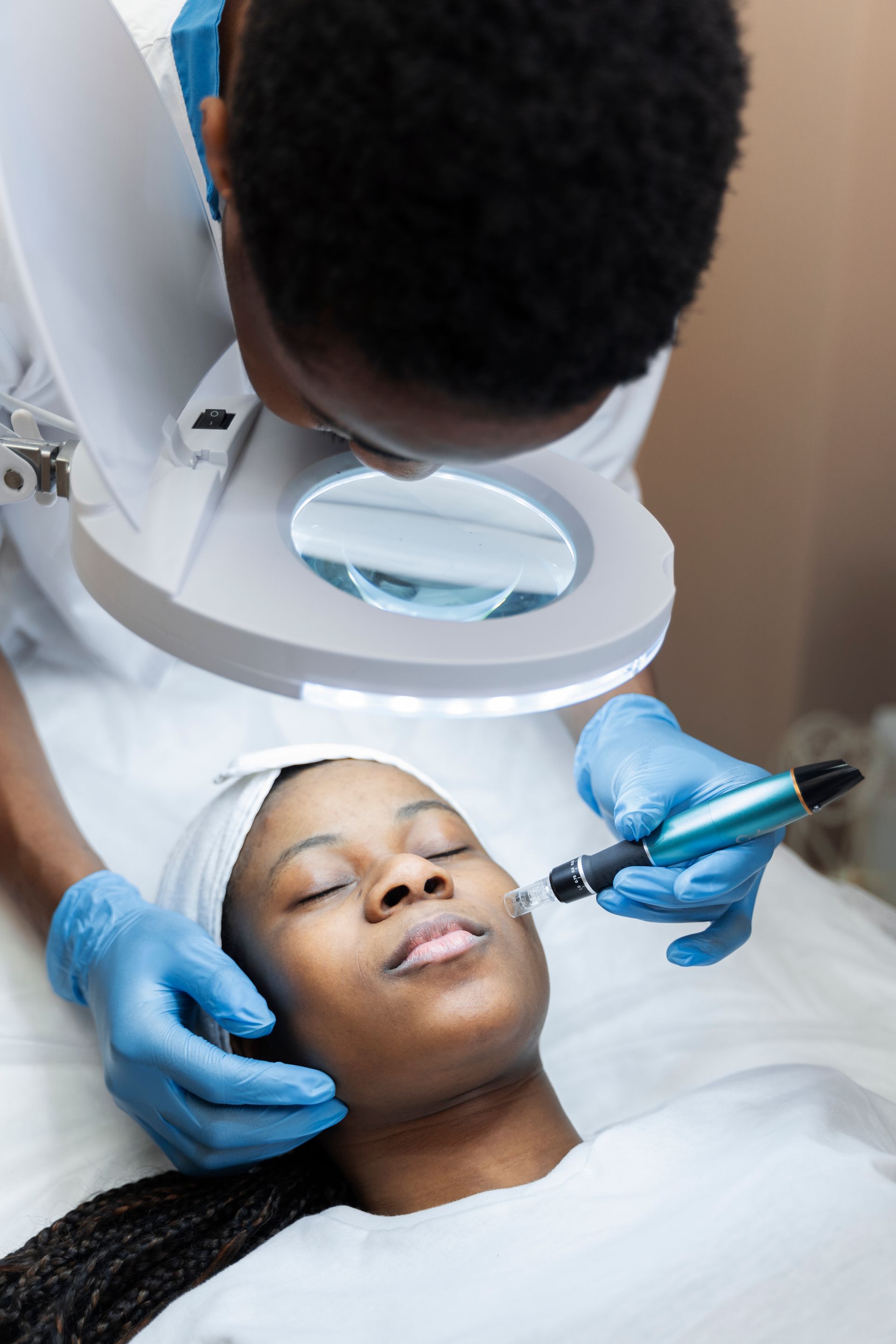 a woman with her eyes closed is getting a facial treatment