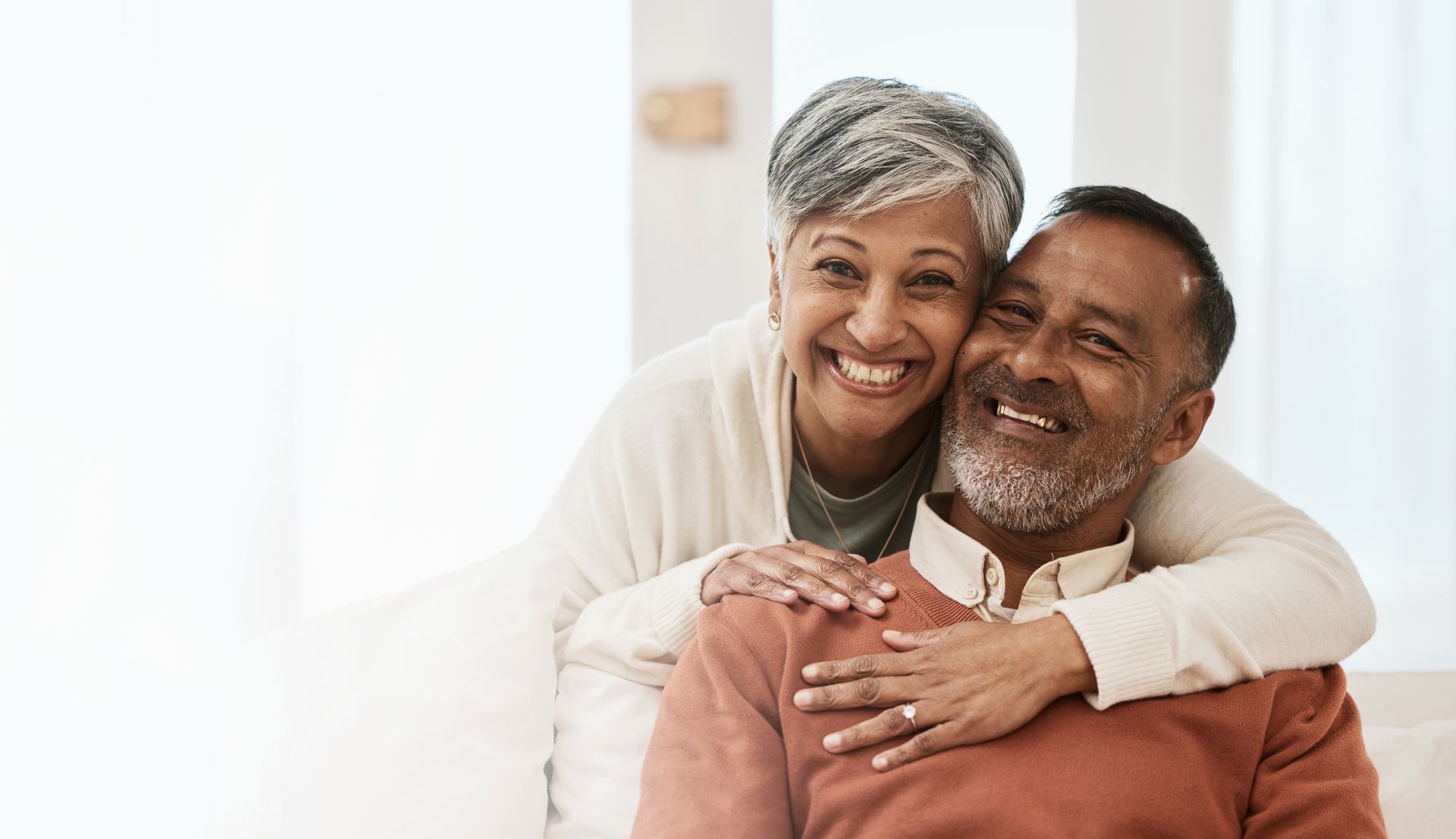 a man and woman are hugging and smiling for the camera