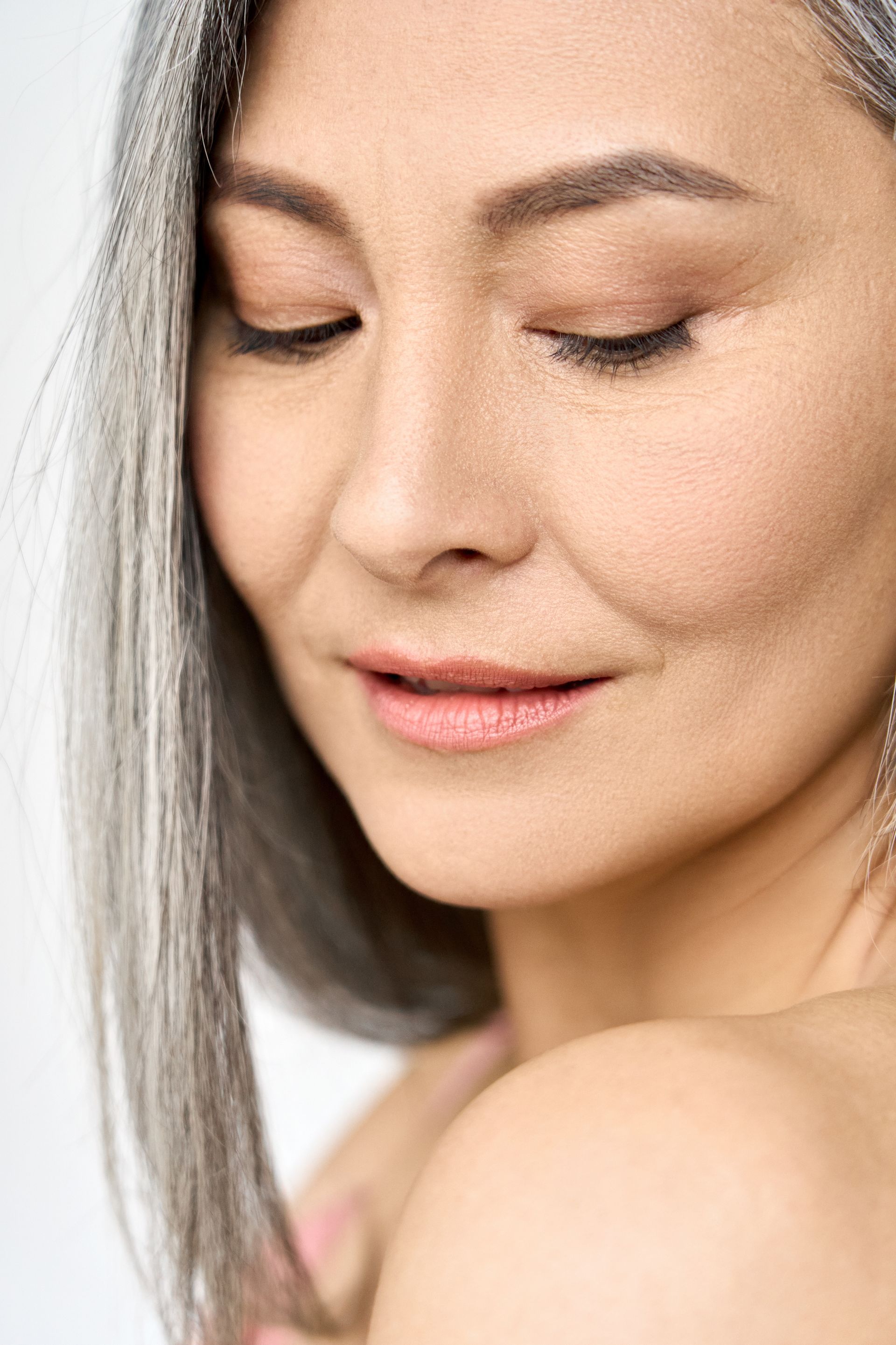 a close up of a woman 's face with her eyes closed
