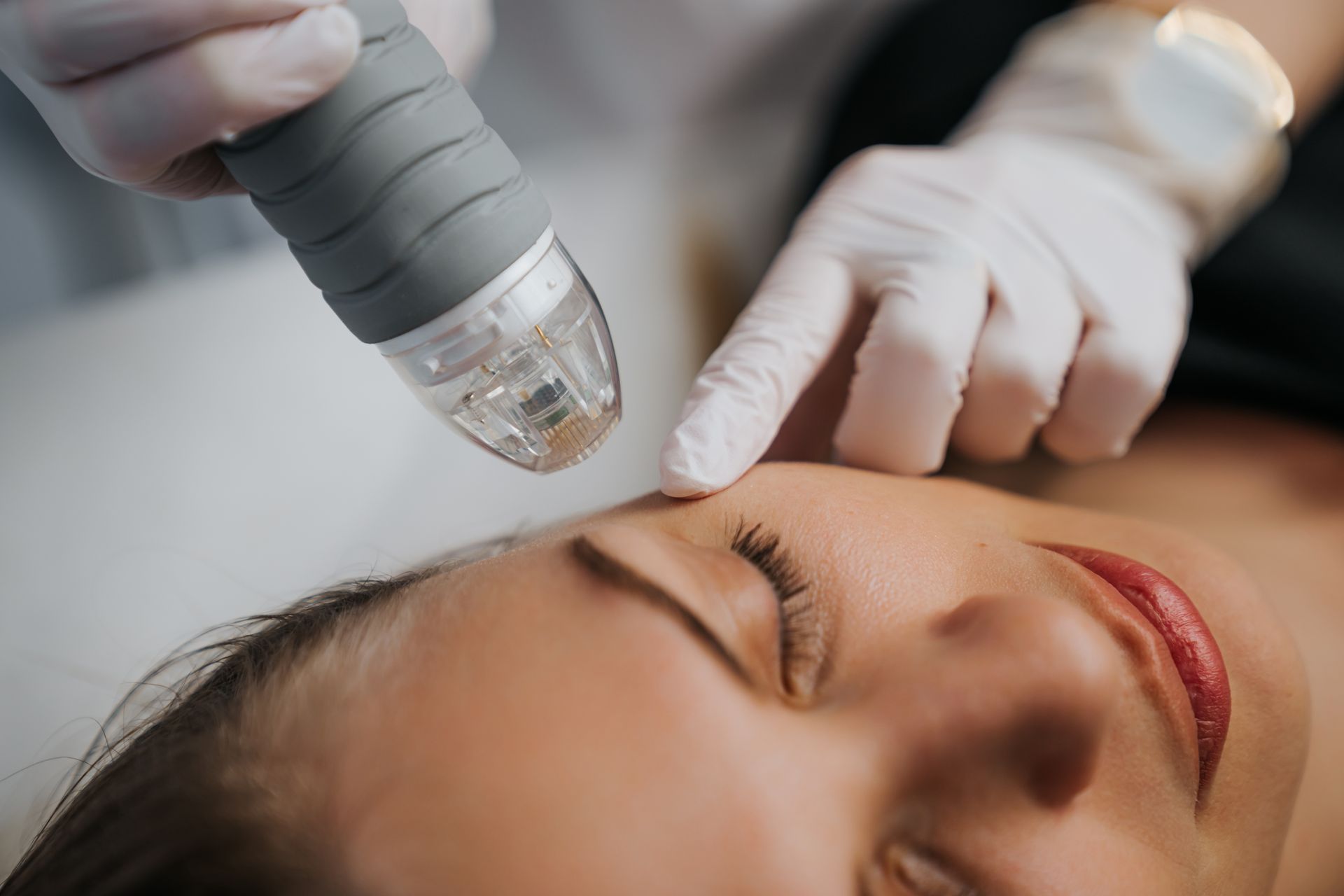 a woman is getting a treatment on her face