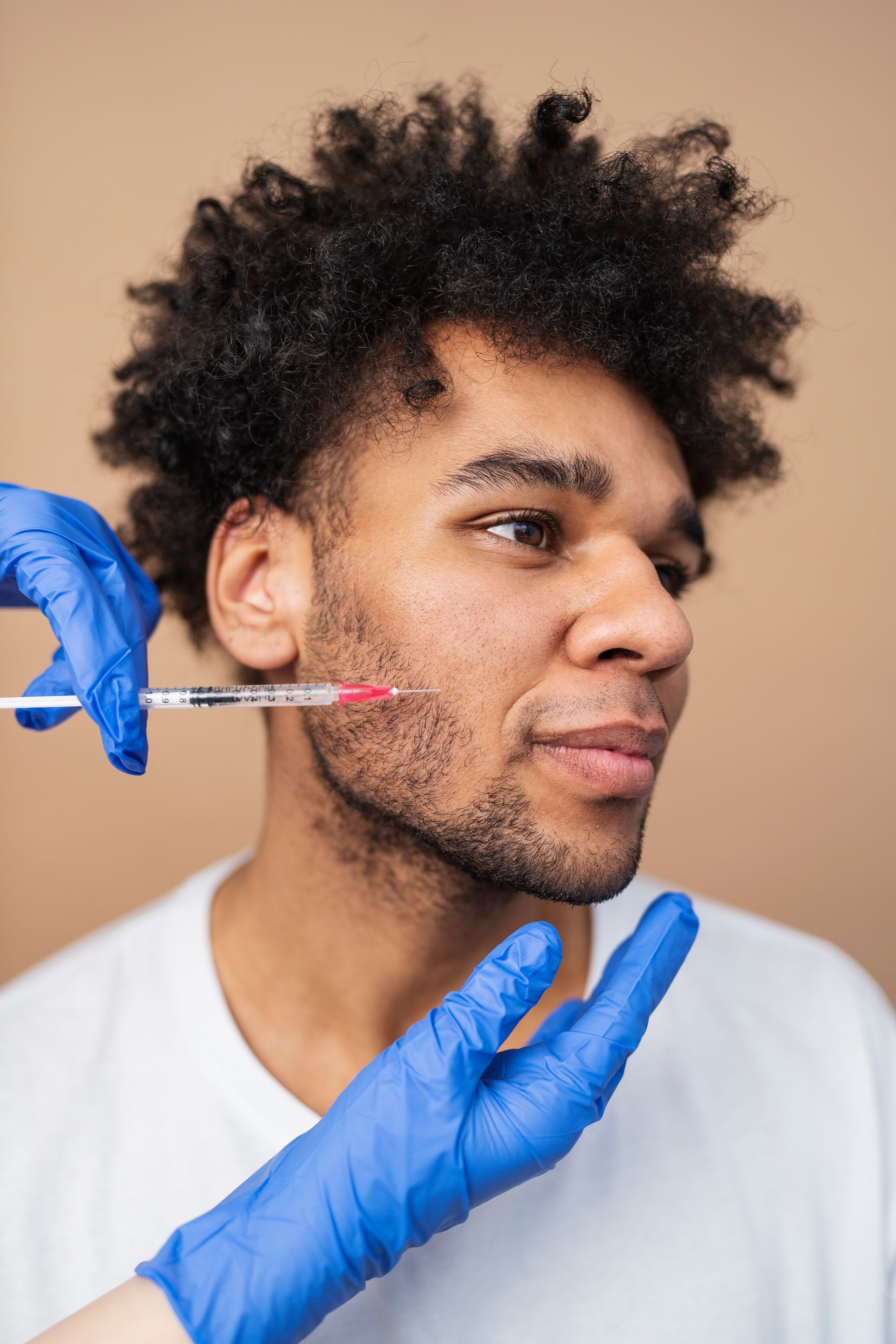 a man is getting a botox injection in his face