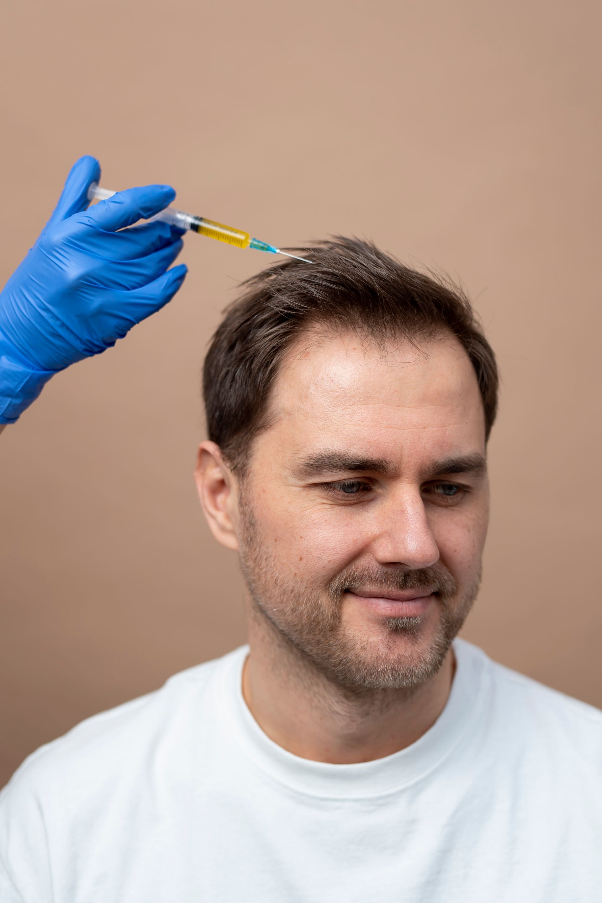 a man is getting an injection in his head