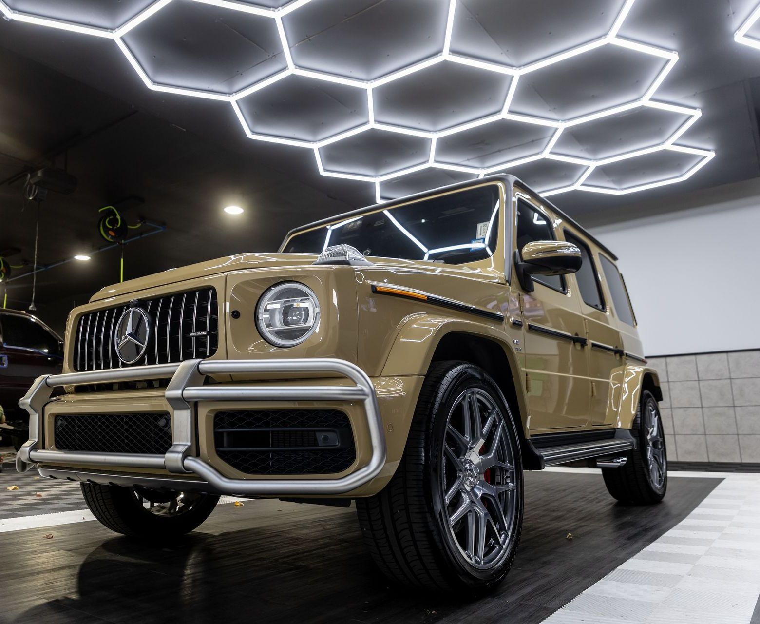 A mercedes benz g63 amg is parked in a garage.
