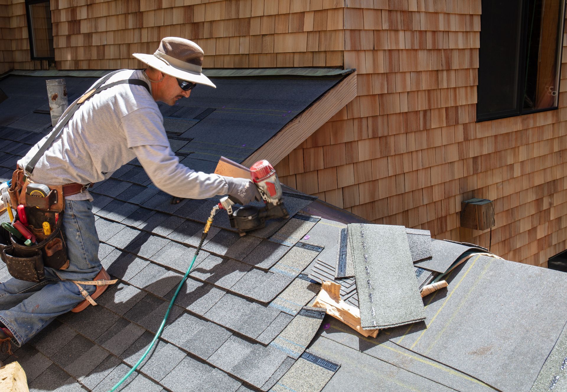 There is a man working on a building's roof.